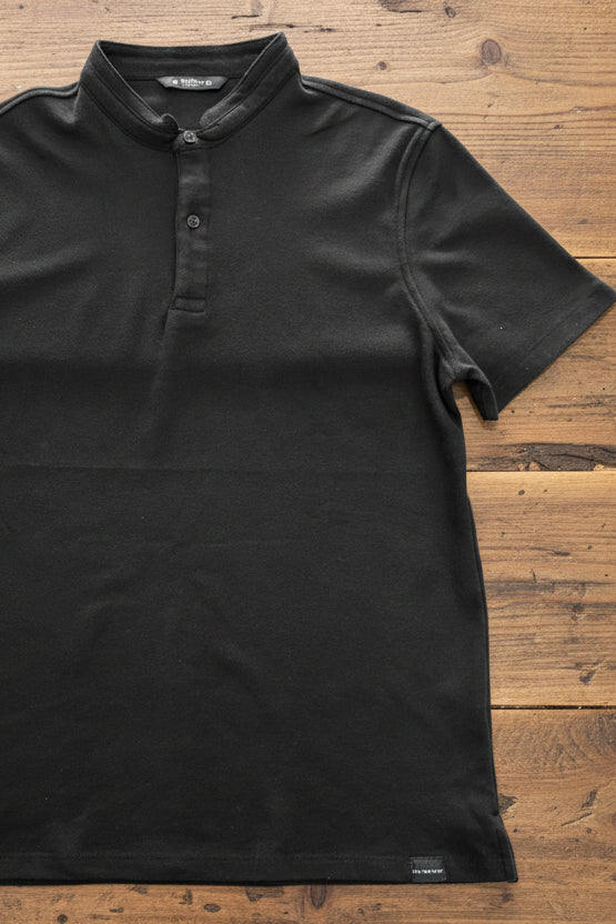 Polo manga corta FITTERS ORIGINALS Holbox en cuello Mao, en colores blanco y negro, con diseño clásico y elegante.